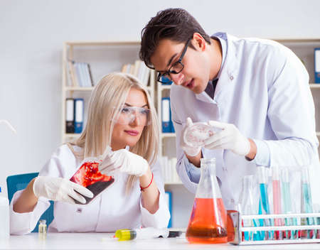 Woman female doctor looking at blood samples in bagの写真素材