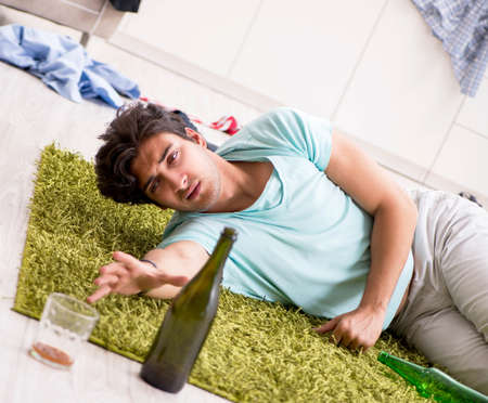 Young drunk handsome man after party at home