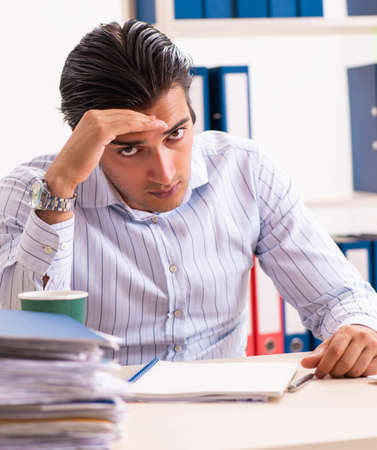 Young employee sitting at the officeの写真素材