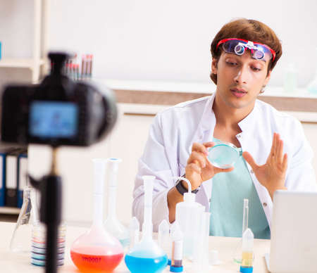 Chemist blogger recording video for his blogの写真素材