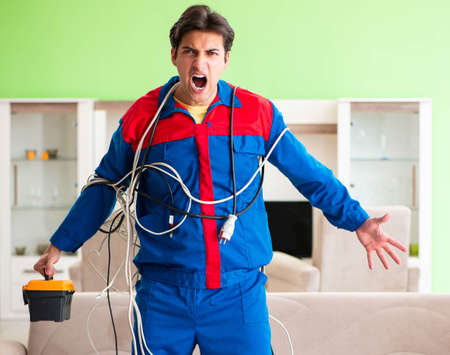 Electrician contractor with tangled cablesの写真素材