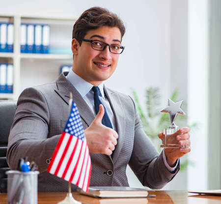 Businessman with American flag in officeの写真素材