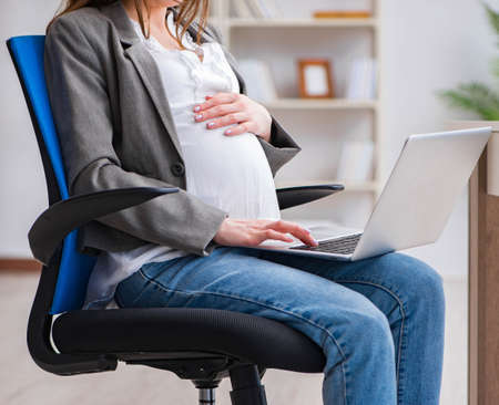 Pregnant woman struggling with pain in office