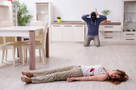 Gangster and young woman in robbery conceptの写真素材