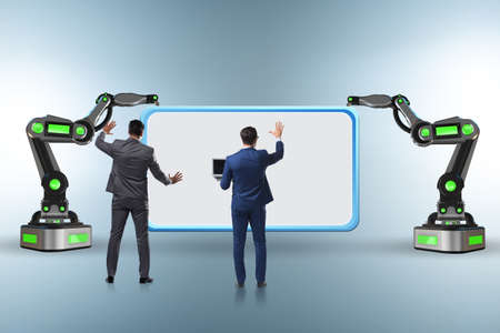 Business people and blank poster supported by the robotic arms