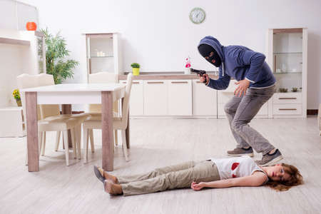 Gangster and young woman in robbery conceptの写真素材