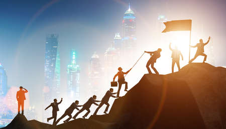 Concept of teamwork with team climbing mountainの写真素材