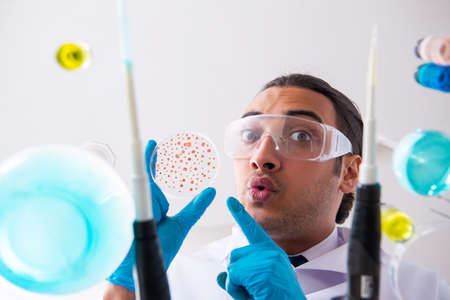 Young male chemist working in the lab