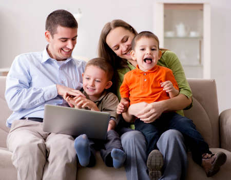Young family surfing internet and looking at photos