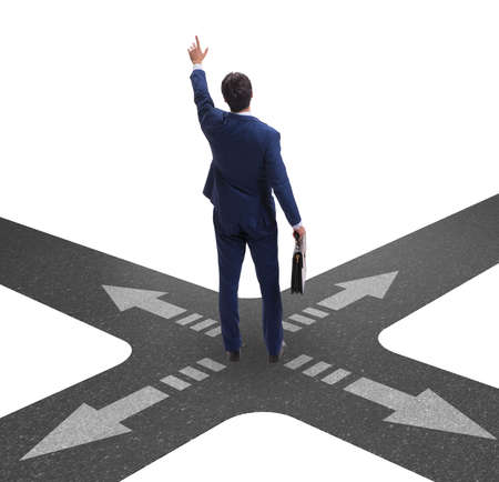 Young businessman at crossroads in uncertainty conceptの写真素材