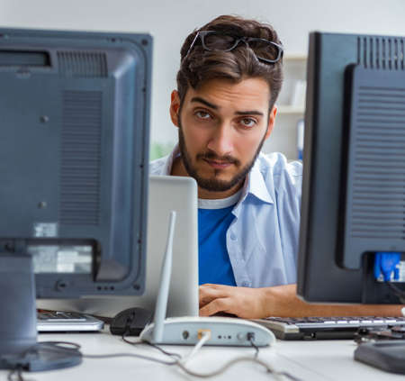 IT technician looking at IT equipmentの写真素材