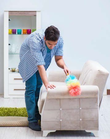 Young family cleaning the houseの写真素材