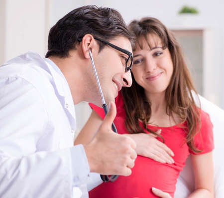 Pregnant woman patient visiting doctor for regular check-upの写真素材