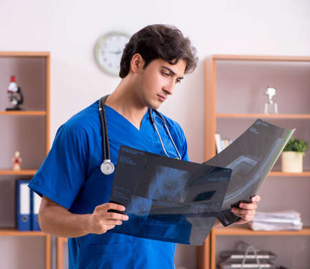 Young handsome doctor working in the hospital