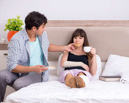 Caring husband looking after his injured wifeの写真素材