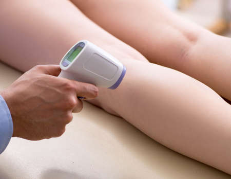 Young woman visiting doctor dermatologistの写真素材