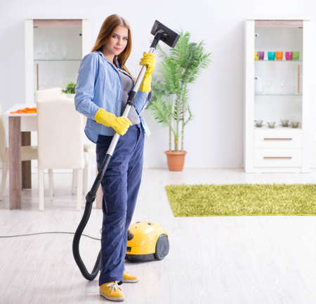 Young woman cleaning floor at home doing choresの写真素材