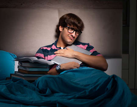 Young student preparing for exams at night at home