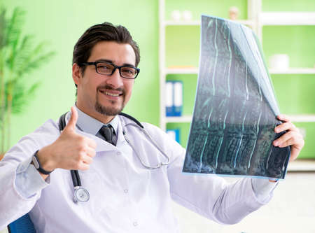 Doctor radiologist looking at x-ray scan in hospitalの写真素材