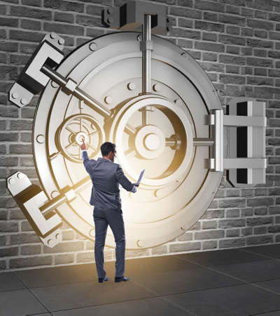 The businessman in front of banking vault doorの写真素材