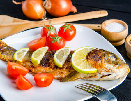 The fried fish served on the plate