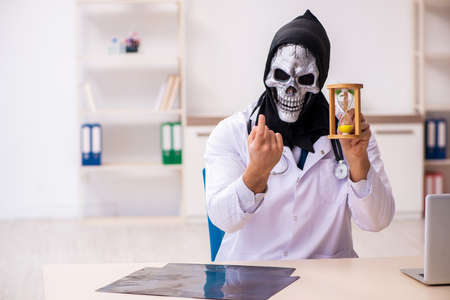 Male devil doctor in time management conceptの写真素材