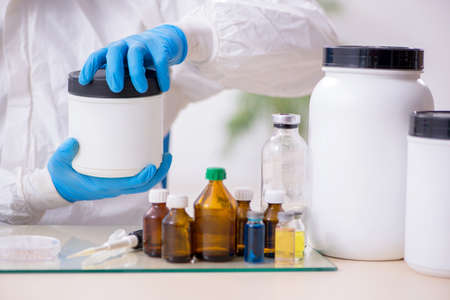 Young male chemist working in the lab