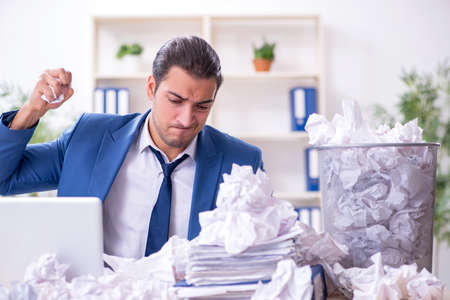 Businessman rejecting new ideas with lots of papersの写真素材