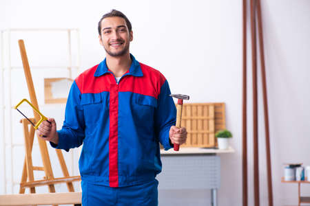 Young male contractor working in workshop