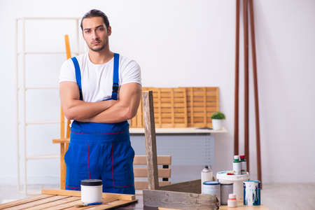 Young male contractor working in workshopの写真素材