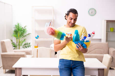 Young male contractor doing housework at home