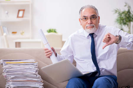 Aged businessman employee working from house