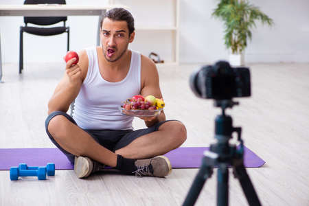 Young male blogger in dieting conceptの写真素材