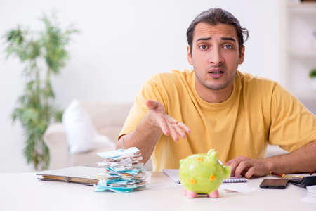 Young man in budget planning conceptの写真素材