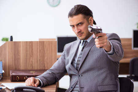 Young male employee unhappy with excessive workの写真素材