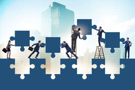 Businessman in the teamwork concept with jigsaw puzzle