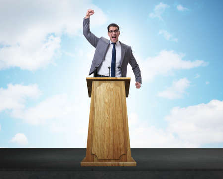 Man businessman making speech at rostrum in business conceptの写真素材