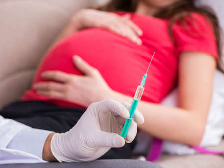 The pregnant woman patient visiting doctor for regular check-upの写真素材