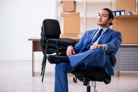 Young male employee in relocation conceptの写真素材