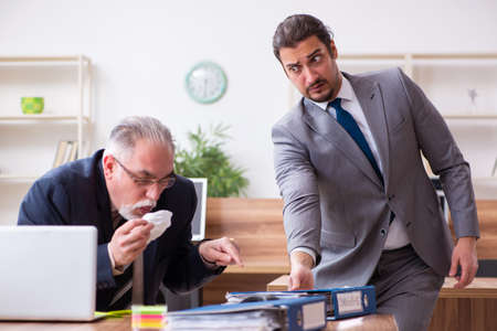 Two employees in pandemic concept at workplace