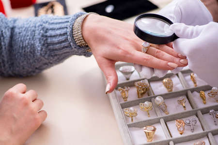 Male jeweler and client at store