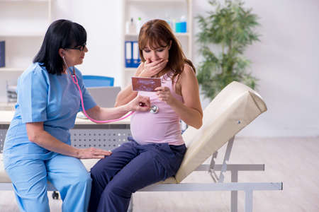 Young pregnant woman visiting experienced doctor gynecologist