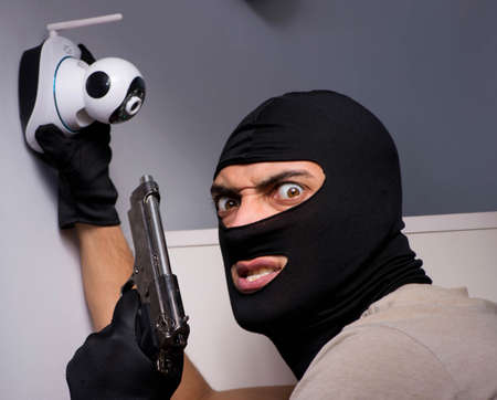Burglar wearing balaclava mask at crime sceneの写真素材