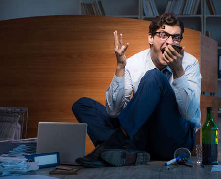 Stressed businessman working overtime in depression