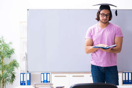 Young male student graduate wearing mortarboardの写真素材