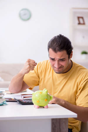 Young man in budget planning conceptの写真素材