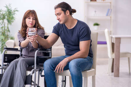Disabled wife and young husband at homeの写真素材
