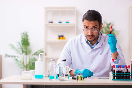 Young male chemist working in the labの写真素材