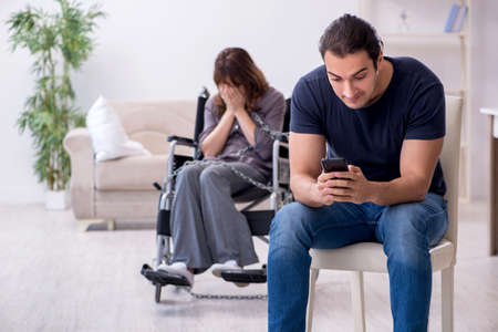 Disabled wife and young husband at homeの写真素材