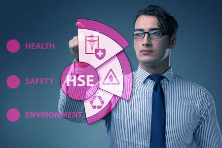 HSE concept with businessman pressing virtual buttonの写真素材